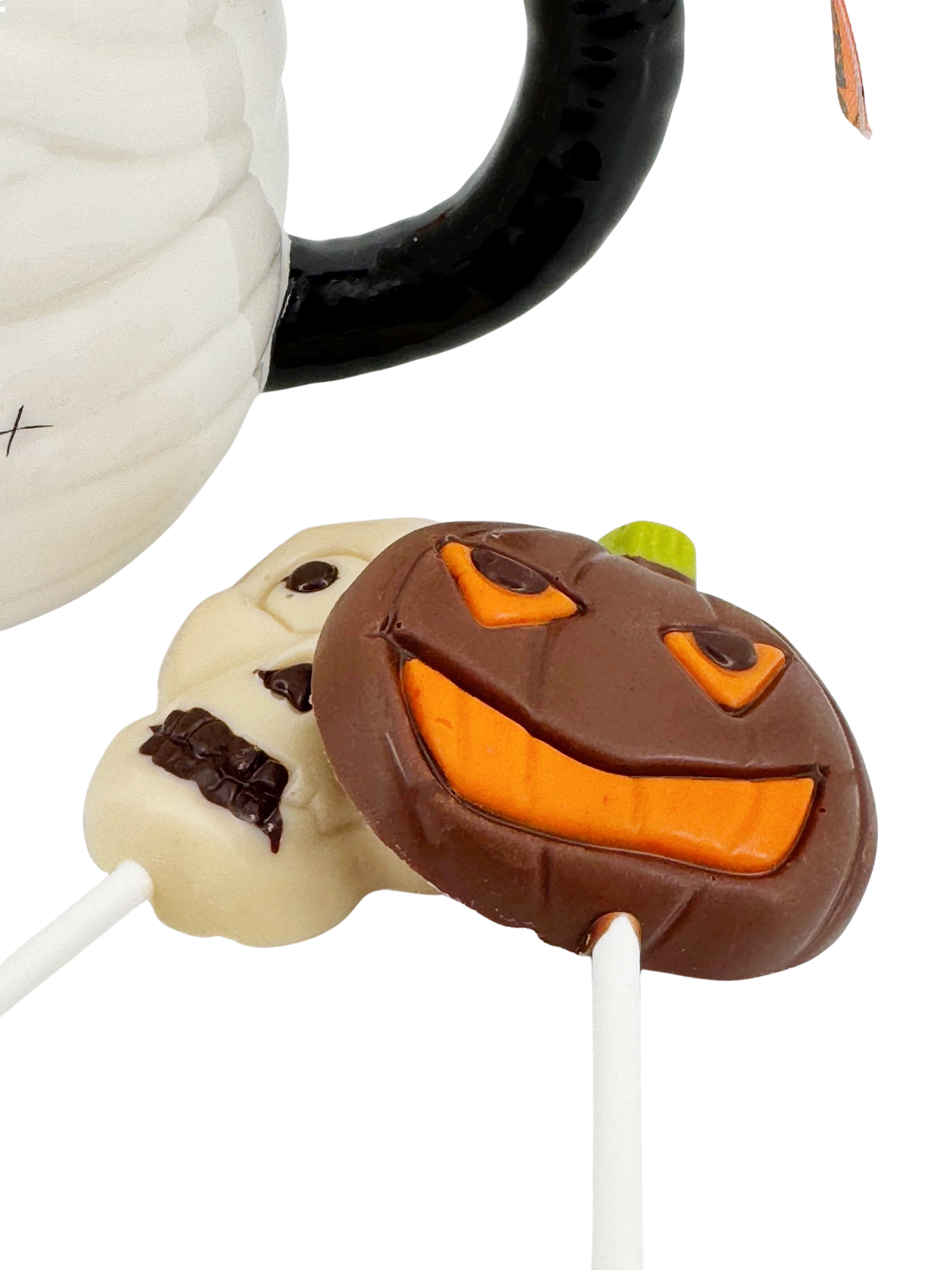 Milk chocolate drops in cup mummy with lollipops