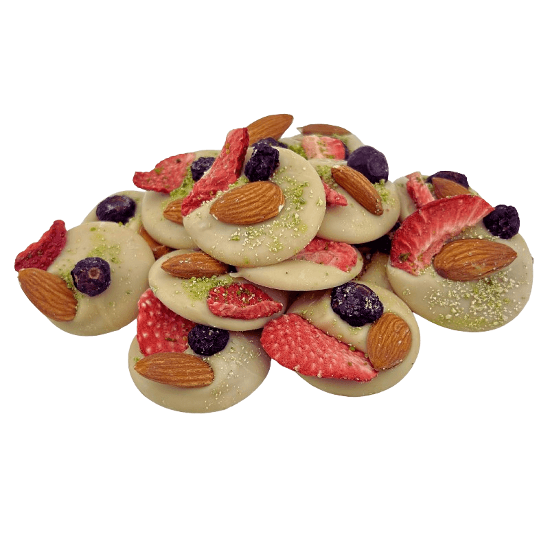 White chocolate mendiants with pistachio, almond, strawberry and blackcurrant pieces